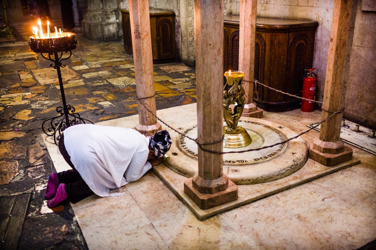 Scene of devotion in the Church of the Holy Sepulchre. Jerusalem, Israel, 2014.